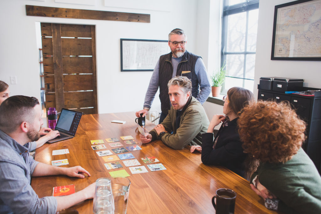 A photo of a client holding and discussing an archetype card during Infantree's archetype workshop.