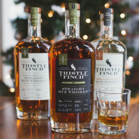 Trio of Thistle Finch whiskey bottles designed by Infantree